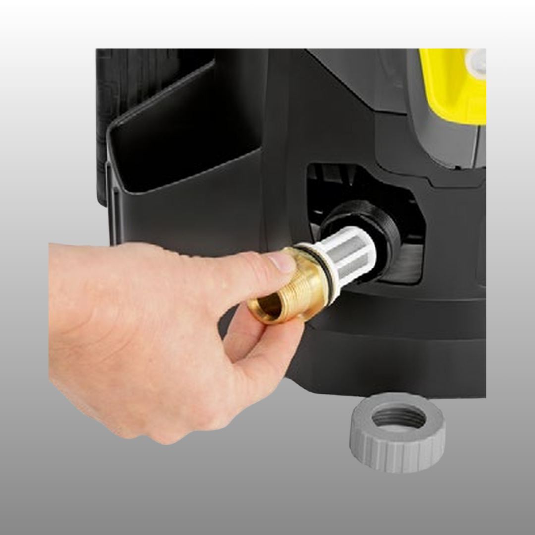 Hand plugging a brass fitting into a black device on a gray background