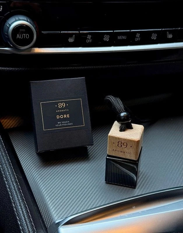 Aromatic 89 hanging glass air freshener in a car