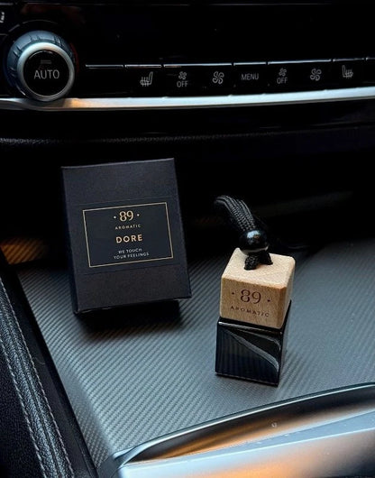 Aromatic 89 hanging glass air freshener in a car
