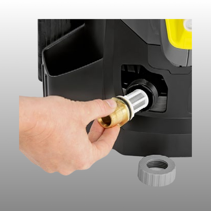 Hand plugging a brass fitting into a black device on a gray background