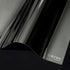 Close-up of black PPF with STEK logo on a dark background